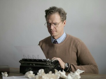 A writer wrestling with language one sentence at a time, symbolising the emotional labour behind storytelling