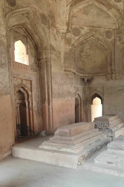 The smaller tomb is generally associated with the Tughlaq period of the fourteenth century, while the larger structure seems to belong to the later Lodi period of the fifteenth century