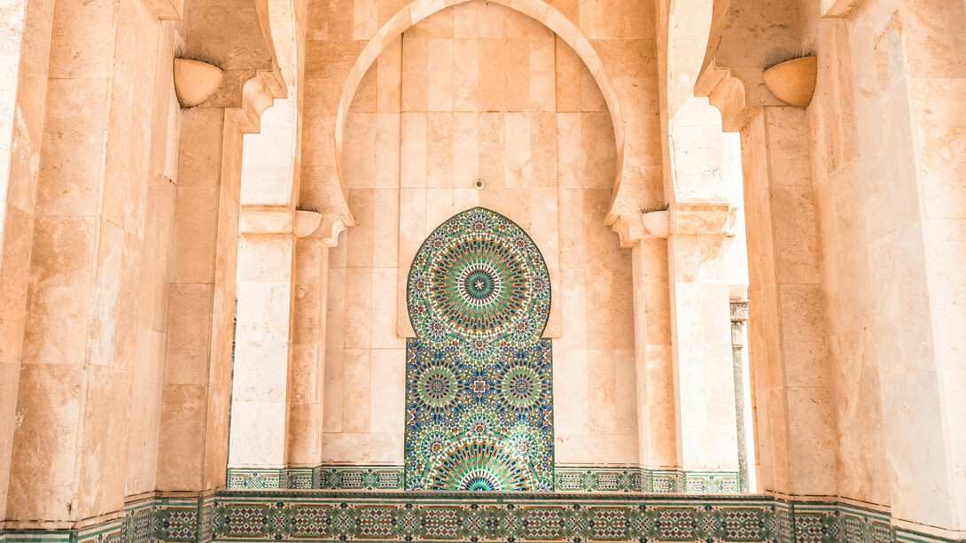 The stunning Moroccan tiles and intricate artistry of the mosque in Casablanca, Morocco, reflect the deep reverence Moroccans have for their sacred places during Ramadan, where spirituality and culture intertwine