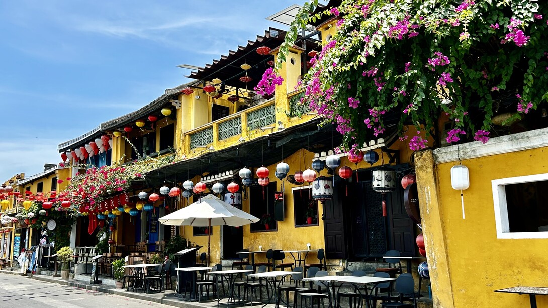 Yellow façades and cascading bougainvillea along Hoi An’s old town streets in Vietnam  ©Alma Reyes