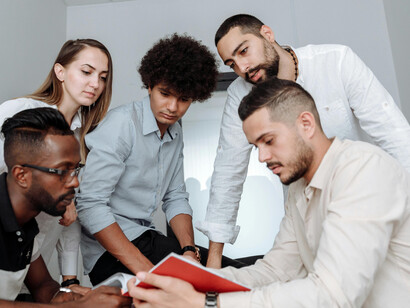 A diverse team works together, reflecting the interconnected nature of global innovation and digital collaboration