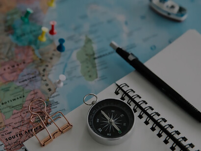 Map, pen, notebook, compass, countries marked on the map