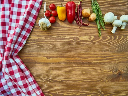 A picnic tablecloth is set to the side to make way for the vegetable and herbs that brought us so many wonderful memories