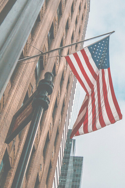 American flag seen against a building in downtown New York, USA