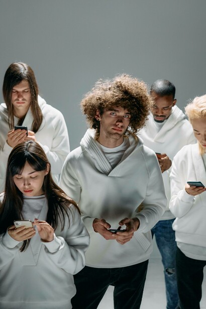 Man staring into the distance with people on their phones
