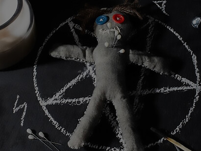 An assortment of voodoo dolls and candles