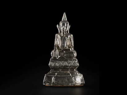 Silver Buddha seated in earth witness pose. A thin sheet of silver is wrapped around a clay core, giving the illusion of a more expensive product. The more valuable the offering, the greater the puñña (merit or virtue) accrued. Myanmar, 18th-19th century, A.1911.478. Courtesy of National Museum of Scotland