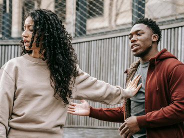 A man forcefully grabbing a woman’s hand as she looks distressed, illustrating tension in a toxic relationship