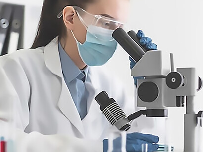In the laboratory setting, a female scientist diligently engages with a microscope, exemplifying focused research and scientific exploration