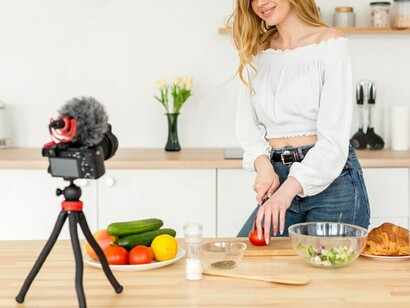 A home cook, doubling as a food influencer, records a video, highlighting the sway of social media on culinary practices