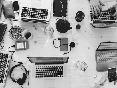 Several co-workers with all their devices together