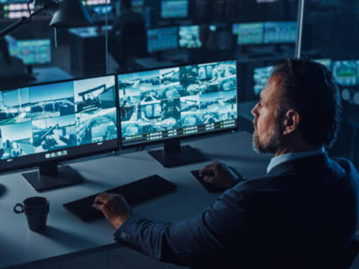 Under constant watch: a male officer reviews real-time CCTV footage