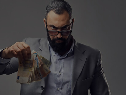 Capitalism symbolized: Bearded gentleman in a suit captures money banknote with flair