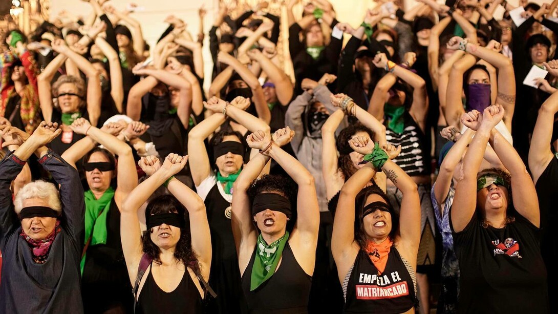 Women standing together in their cause to combat femicide in Latin America