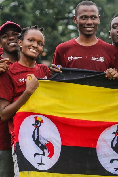 Ugandans hold their flag in pride