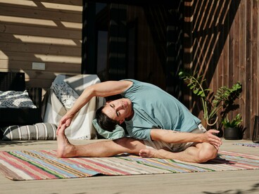 A yoga balance held with precision, representing the connection between resilience, awareness, and physical control