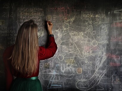 A teacher on a blackboard. Some are concerned with digital literacy