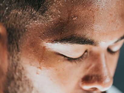 Man sweating, representing the rising temperatures as a result of climate change