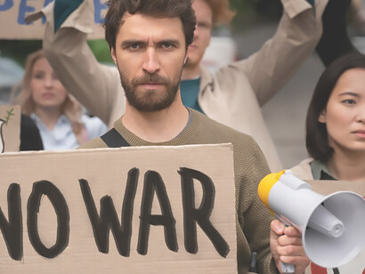 A group of impassioned young individuals actively participates in an anti-war protest, fervently holding aloft cards bearing the powerful message, "No war"