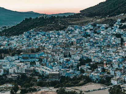 The famous blue city of Chefchaouen surrounded by rugged mountains, symbolizing the historical depth of Moroccan civilization