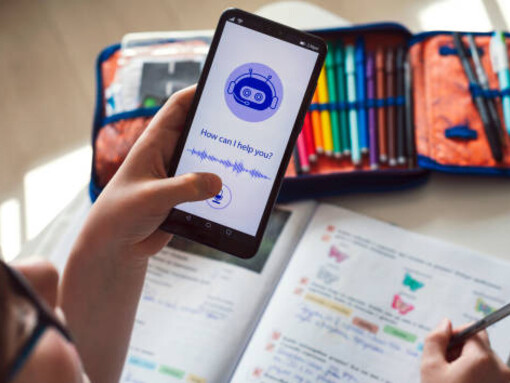 A happy boy interacts with an AI chatbot on his mobile device, demonstrating the power of artificial intelligence technology and the role of virtual assistants in modern communication