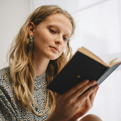 Woman reading a book indoors