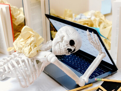 Skeletal figure drowning in the abyss of work-induced stress