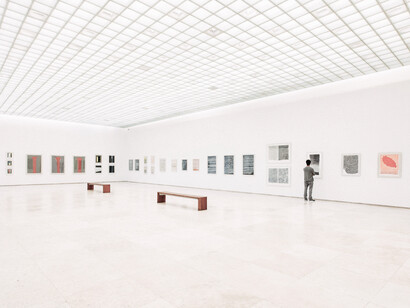 Museum-standard lighting on assorted paintings against a white wall, focusing on gallery light design and conservation techniques