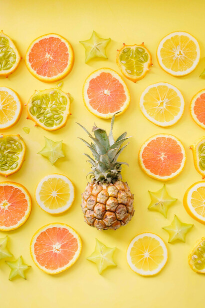 Fruits against a yellow background represent the positive consequences of healthy eating 