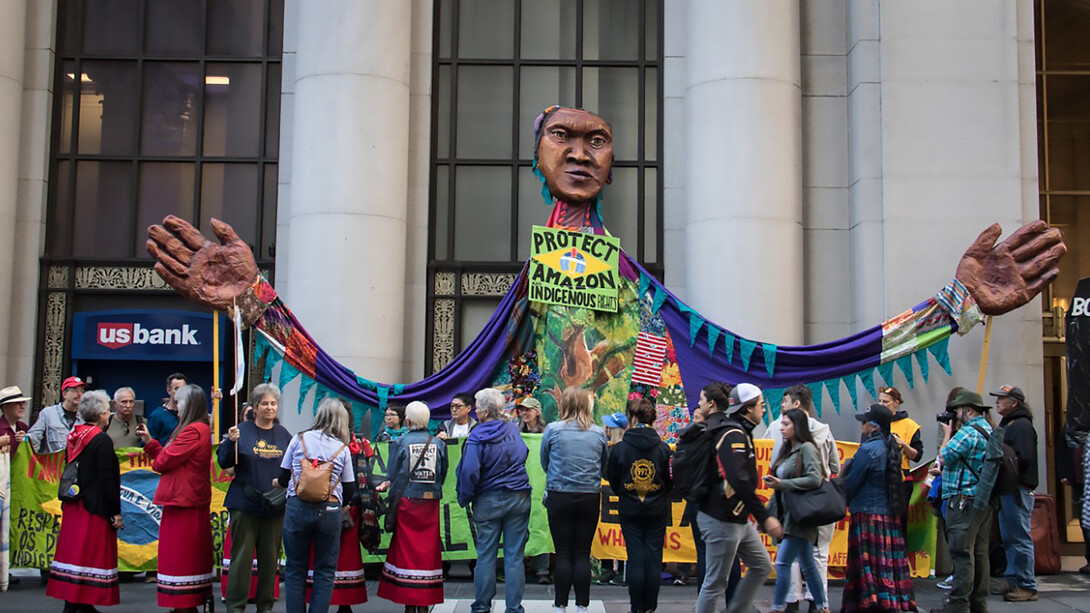 A giant puppet, street mural, and road blockade outside the Brazilian Consulate in San Francisco, California, call on President Jair Bolsonaro to protect the Amazon and respect Indigenous rights