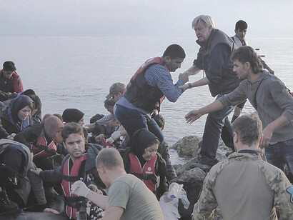 A group of Syrian refugees safely arrives in Skala Sykamias, Lesvos island, Greece aboard an inflatable boat, seeking refuge and safety