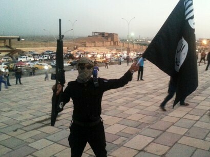 Daesh member flying a flag
