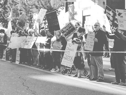 Protestors behind a police cord in the USA carrying banners and exercising their democratic right to be heard