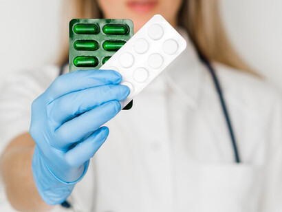 A female doctor's hands with pills, highlighting oral medication and advancements in drug delivery