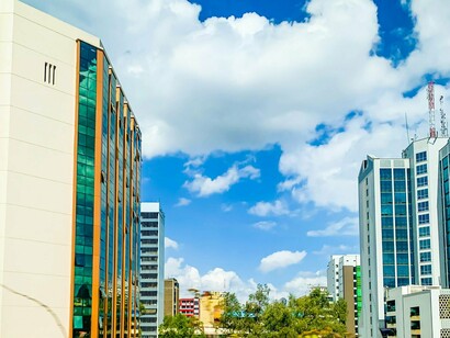 Nairobi’s modern skyline beneath a bright blue sky, representing Kenya’s rise as a pioneer in mobile financial innovation
