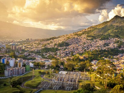 The cityscape of Medellín in the evening light, reflecting Colombia's economic and cultural influence that continues to strengthen ties throughout Latin America