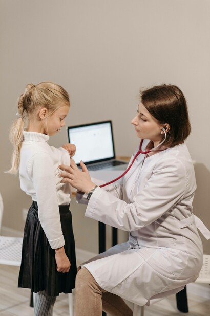 Doctor checking heartbeat of child