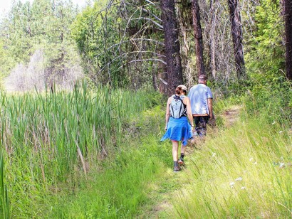 A couple enjoying a lovely hike in nature and enjoying the relationship they have with it