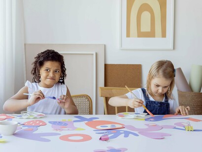 Two children painting at a table together 