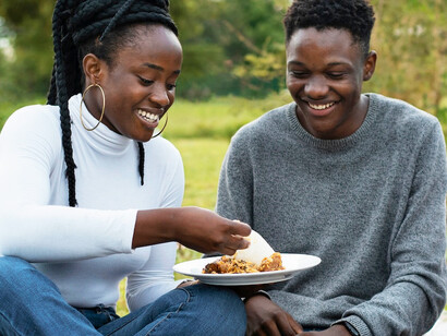 Eating with their hands, these friends embrace tradition and togetherness, showing how food rituals nourish both body and spirit