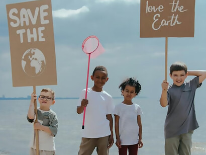 Behold the inspiring sight of children, well-versed in the urgency of the climate crisis, as they hold banners declaring "Save the World" and "Love the Earth" — a powerful testament to their commitment to a sustainable future