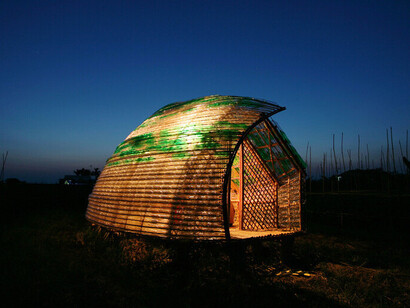 The Bottle Sail in Haiphong, Vietnam, glows under a deepening sky, its translucent plastic bottles catching the last golden rays of the Vietnamese sunset