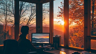 A founder at work overlooking the beauty of nature, reflecting the harmony between focused productivity and the natural world