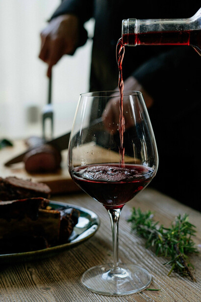 A person gracefully decanting wine into a glass