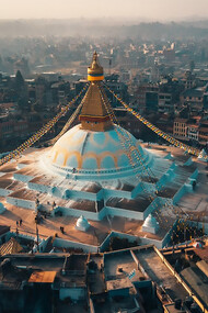 An aerial view of city buildings during the daytime with the Bodhnath Stupa in Kathmandu, Nepal