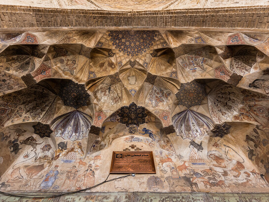 The vaulted ceiling at the entrance of the Ganjali Bathhouse, built in 1631 as part of a larger architectural complex in the old center of Kerman, Iran, features frescoes adorned with Safavid-era ornaments