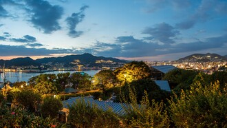 The evening lights of Nagasaki seen from Glover Garden cascading across the hillsides, reflecting the city's warm and enduring spirit 