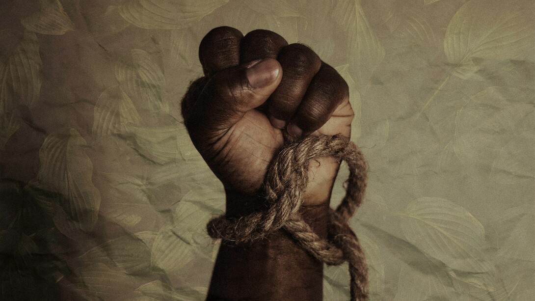 A bound hand clenched in resistance, the rope tightening around the wrist as a stark reminder of how slavery reduced human beings to property