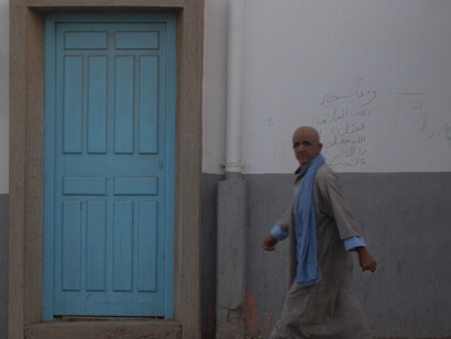 Tranquility reigns supreme on the quiet streets of Tan-Tan, where locals move gracefully through the city's timeless thoroughfares