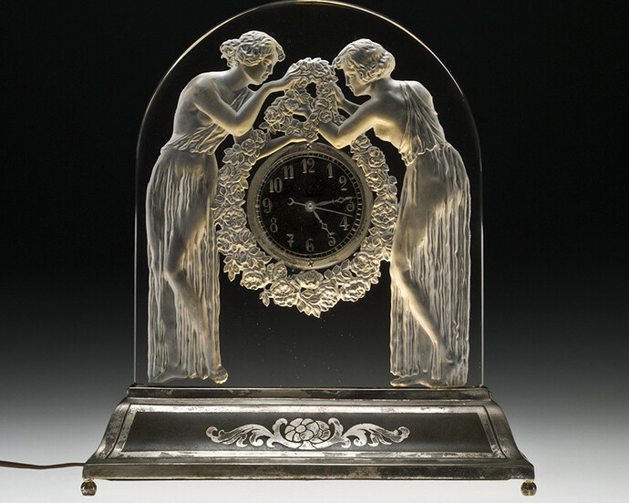 René Lalique, Designer, Lalique et Cie, Manufacturer, Deux figurines (Two figures)
Clock with illuminated base: Colorless glass, mold-pressed; metal clock parts, assembled.
Designed 1926